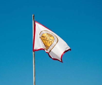 Flag of town of Dubrovnik flying from pole