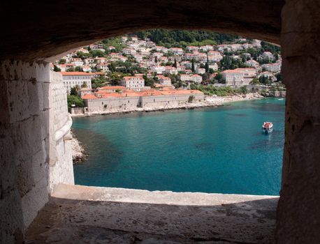 View over rooftops of Dubrovnik to tower and distant ocean