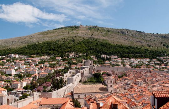 View over rooftops of Dubrovnik to tower and distant ocean
