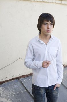 close up portrait of young serious handsome smoking man with cigarette