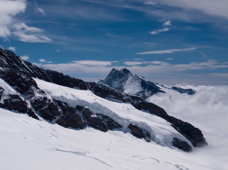 Jungfraujoch in Swiss Alps showing station and distant peaks above clouds