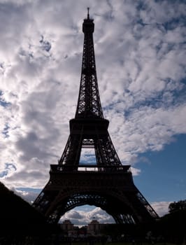 Shape of Eiffel Tower against a blue cloudscape in Paris