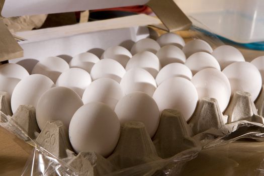 White eggs in box standing on table on kitchen