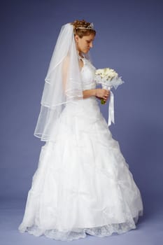Young bride in white wedding dress with a bouquet