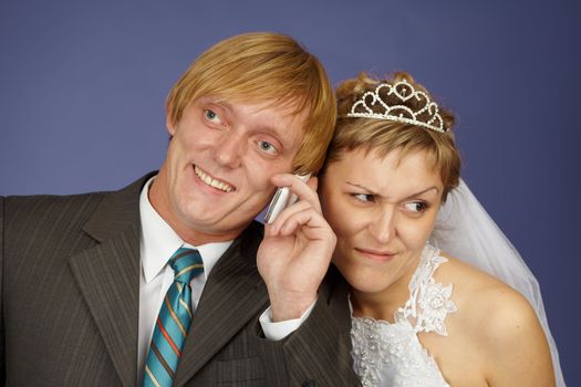 The groom calls on a cell phone, and the bride overhears