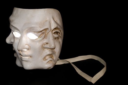 A mask with three faces showing three states of mind