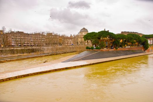 View across the River Tiber to Isola Tiberina in Rome. The island was modeled to resemble a ship by the romans in the 2nd century BC