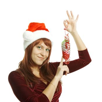 The woman in a Christmas cap holds a glass ornament in a hand