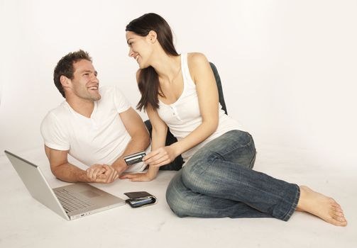 Couple shopping on internet paying by credit card.