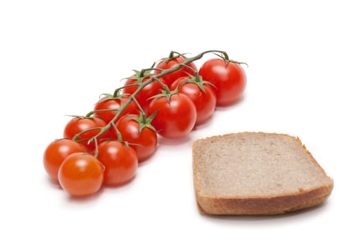 Branch red tomato cherry on piece of the pumpernickel