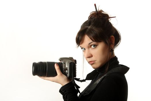 The beautiful girl with a camera on a white background