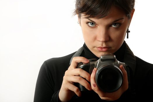 The beautiful girl with a camera on a white background