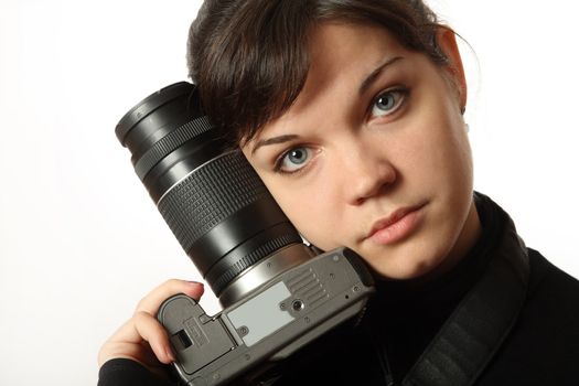 The beautiful girl with a camera on a white background