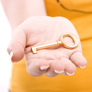 Yellow big key on female palm close-up