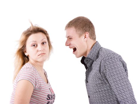 On white background the young man strongly shouts at the young woman