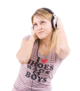 The girl sits on floor and with pleasure listens to music