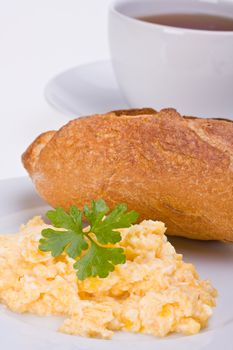 scrambled eggs and bun on a plate