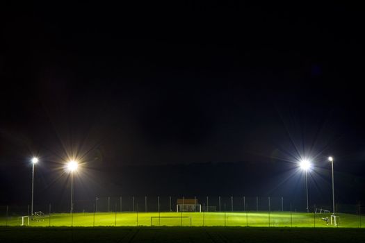 empty soccer pitch illuminated at night