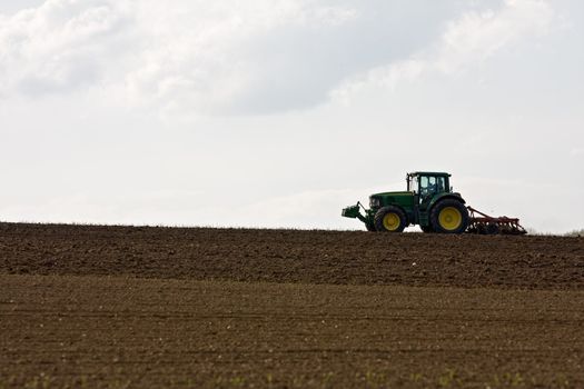 silhouette of a tractor on farmland