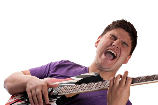 A man in his late teens playing his electric guitar over a white background.