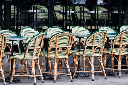 Wicker chairs in cafe in Paris. Photo with tilt-shift effect