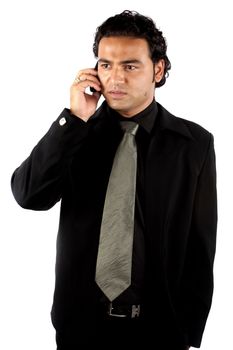 A young Indian businessman talking on the phone.