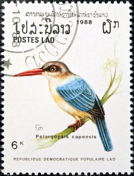 LAOS - circa 1988:stamp features a Stork-billed kingfisher bird (pelargopsis capensis), circa 1988 in the Lao People's Democratic Republic.