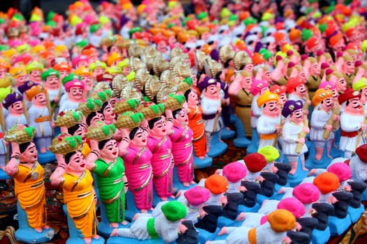 A background of traditionally made colorful clay toys of vintage soldiers, rural people and warriors for sale during Diwali festival in India.