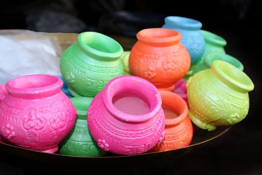 Colorful pots in traditional religious designs, for Diwali festival rituals.