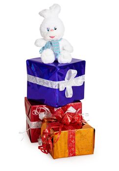 A toy rabbit, and other Christmas gifts on a white background