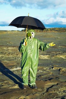 Man in suit and gas mask with umbrella waiting for acid rain