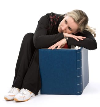 Young women with book sitt on the floor. White background