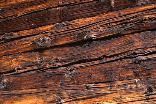 Facing of wooden boards of a wall. Side of an old alpine refuge