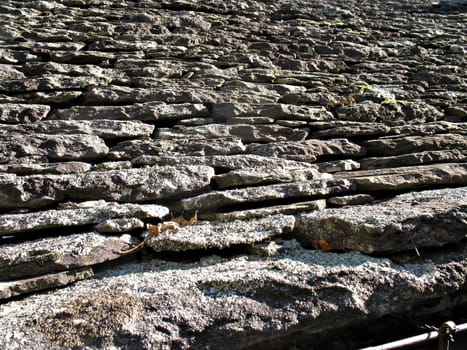 An old roof with tiles made of stones