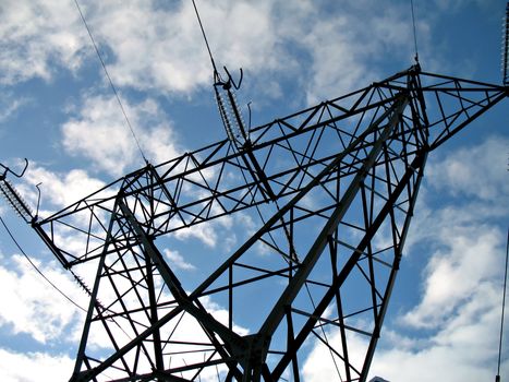 A silhouette of an hydroelectric high-voltage electrical line in mountain