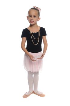 cute young girl posing in a dance costume on a white background