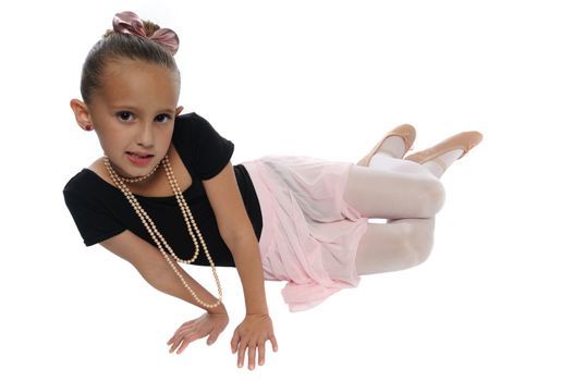 cute young girl posing in a dance costume on a white background