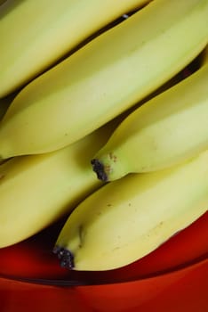 bunch of bananas on a red elegant plate