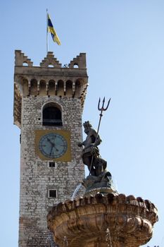 view from Piazza Duomo of the Nettuno fountain with the Torre Civica in background, Trento, Italy