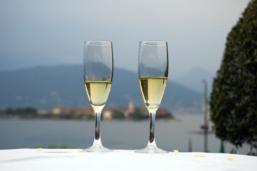 Two glasses of white wine in a restaurant on the lake Maggiore shore, Italy