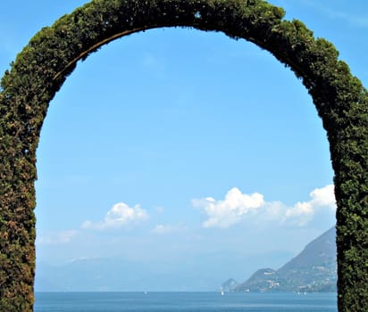 A fence arch-shaped in front of the lake. lago Maggiore, Italy