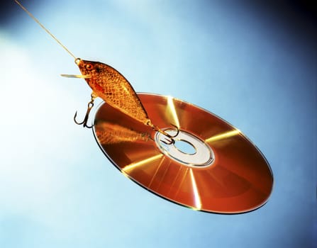 Cd and lure isolated on a blue background