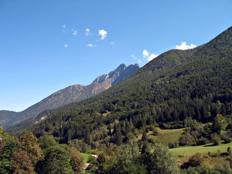 A mountain landscape in Valle Vigezzo, Italy,  wood and peaks at the beginning of fall season