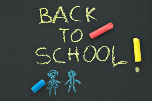 blackboard with the notice "BACK TO SCHOOL" and chalks