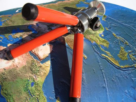 planning a tour around the world, atlas map and tripod