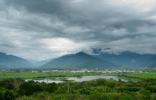 It is a beautiful mountain and clouds with tree.