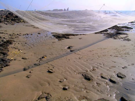 fishing net spread near the seashore