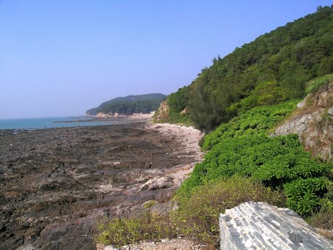 seahore, rocks and green hills