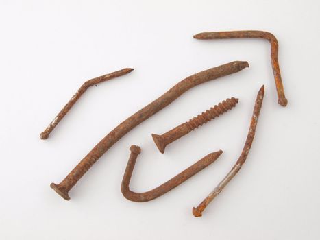 Old rusty, bent nails  with a single screw.