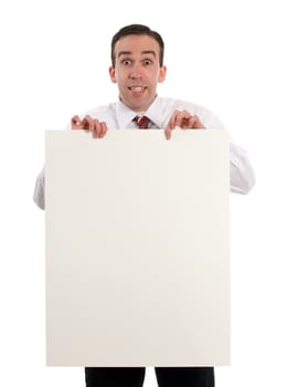 A young businessman holding up a blank sheet of paper, isolated against a white background
